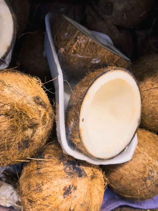 Halved coconuts showing fresh white flesh