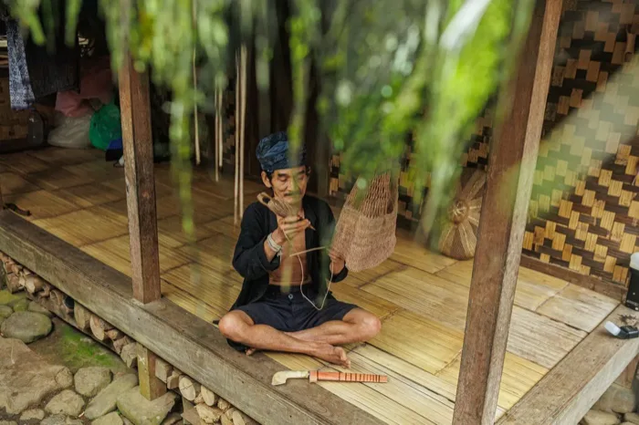 Indonesian artisan weaving a rattan basket by hand
